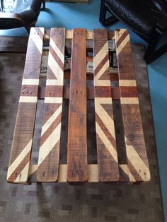 a coffee table made out of pallet wood with the british flag painted on it