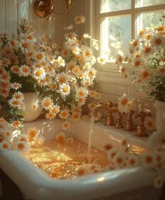 a sink filled with lots of white flowers next to a tub full of water and gold faucets