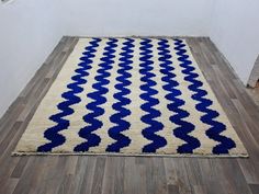 a blue and white rug on the floor