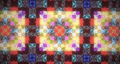 a colorful quilt with many different designs on it