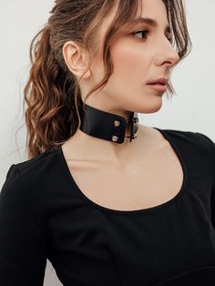 Show off your gothic side with the Sabrina Choker, a striking accessory made from leather and adorned with solid stainless steel barbels and screws. This choker is perfect for those who want to make a statement and add a touch of edge to their outfit. Whether you're attending a concert or a night out with friends, the Sabrina Choker is the ideal choice for elevating your style game Edgy Choker For Alternative Fashion, Rocker Style Festival Choker Jewelry, Edgy Black Choker For Alternative Fashion, Gothic Leather Jewelry For Party, Edgy Leather Choker, Edgy Leather Choker Jewelry, Edgy Adjustable Rivets Choker, Edgy Rivets Jewelry, Adjustable Edgy Leather Choker