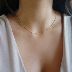 Gold Dainty Sparkle Chain Delicate Thread Chain Minimalist Layering Choker Tiny Chain Necklace Jewelry Gift for Women The perfect add on to any wardrobe, shiny and dainty, goes with casual or more elegant style. Great to combine with other pieces from our shop for a layered look. Delicate chain gold plated / rhodium plated over stainless steel. Very thin and delicate 1.5mm, with flattened beads that sparkle like little mirrors. Sturdy, high quality. Minimalist Necklace Layering, Decent Gold Jewellery, Small Gold Chain For Women, Minimalist Chain Necklace, Good Chains Women, Small Dainty Jewelry, Modern Gold Chain Designs For Women, Simple Chains For Daily Use, Dainty Gold Choker