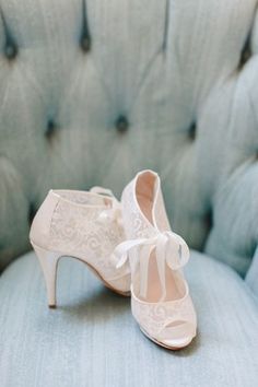 a pair of white shoes sitting on top of a blue chair