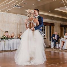 a bride and groom are dancing on the dance floor