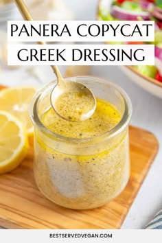 panera copycat greek dressing in a glass jar with a spoon and lemon wedges