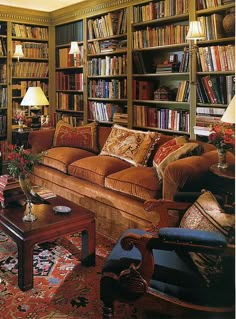 a living room filled with lots of furniture and bookshelves full of books on shelves