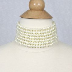 This beautiful and classic pearl choker is made of 7 strands of high quality glass pearls! The size of the pearls is 8mm, the perfect size for chunky multi strand pearls. A pair of free matching earrings are included. This style requires an accurate measurement of your neck circumference if you would like the necklace to wear close around your neck. If between sizes, please pick the shorter size. the choker is made with very comfortable elastic material and comes with a 2.5" extender. It's very easy to adjust if it's a little tight. If the choker is loose, it doesn't stay close on neck very well.   If the length you would like is not listed, please let us know and we will knot the necklace according the length you provided. If it's a gift, we can do it in the common length of 13.5" with a White Pearl Choker, Pearl Necklace Bridal, Statement Necklace Wedding, Chunky Pearls, Bridal Pearl Necklace, Pearl Necklace Vintage, Necklace Bridal, Necklace Wedding, Necklace Statement