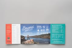 an open brochure is displayed on a gray surface with blue and orange accents