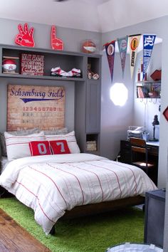 a bedroom with a bed, desk and shelves on the wall above it is decorated in red and white