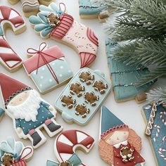 decorated cookies on a table next to a christmas tree