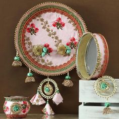 an assortment of jewelry is displayed on a table with other items in front of it