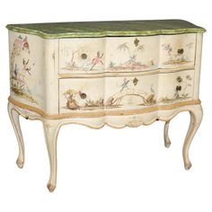 an old dresser with painted flowers and birds on it