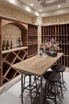 a wine cellar with lots of bottles and stools