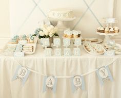 a table topped with lots of desserts and cupcakes