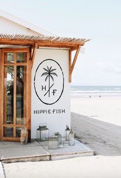 a sign that says hippie fish on the side of a building near the beach