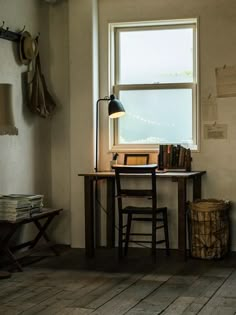 a room with a desk and chair next to a window on the wall is filled with books