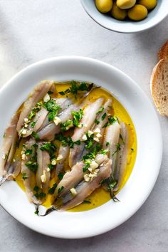 an image of fish with olives and bread