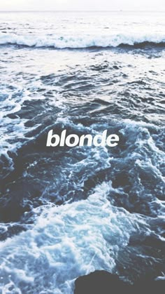 the words blonde are written in white on an ocean background with rough waves and foamy blue water