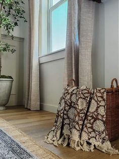 a brown and white bag sitting on top of a wooden floor next to a window