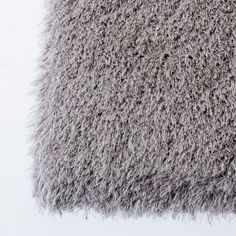 a close up view of a gray shaggy rug