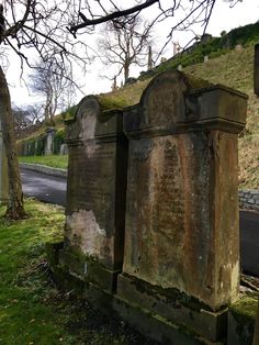 an old cemetery with moss growing on the top