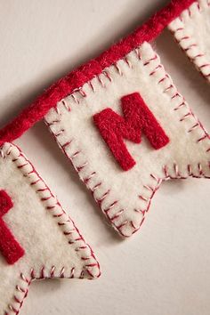 a red and white banner with the letter m hanging from it's side on a wall