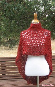 a crocheted shawl on top of a white mannequin headdress