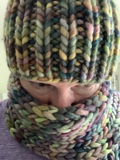 a person wearing a knitted hat and scarf