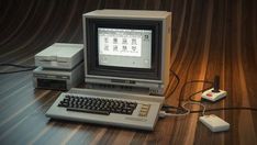 an old computer sitting on top of a wooden table