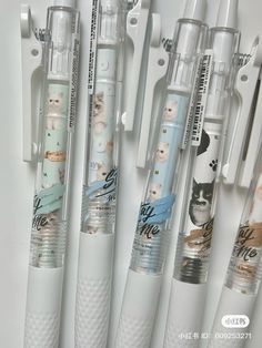 five different types of toothbrushes lined up in a row on a white surface