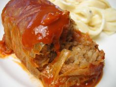 the meatloaf is covered with gravy and served with macaroni and cheese