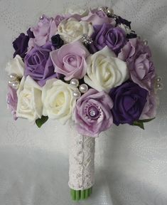 a bridal bouquet with purple and white flowers