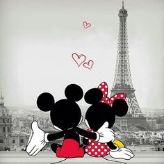 two mickey and minnie mouses hugging in front of the eiffel tower, paris