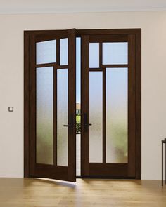 an open double door in a room with wood floors