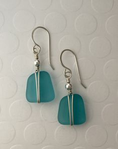 the earrings are made with sea glass and silver