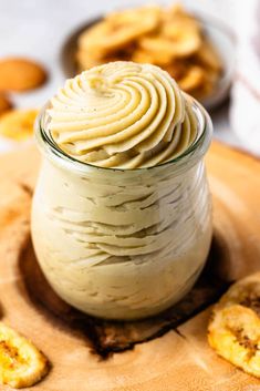 a jar filled with whipped cream sitting on top of a wooden cutting board