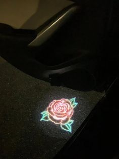 a close up of a car dashboard with a rose on it