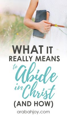 a woman in white dress holding a book with the words what it really means to abdle in christ and how