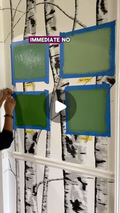 someone is painting a wall with trees on it