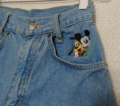 Mickey by Jerry Leigh Vintage High Rise Jeans With Embroidered Mickey/Pluto Logo Pre-owned in good condition. Measurements in inches laying flat.Approx Waist: 12" Rise: 12 1/2" Inseam: 30" Leg opening: 6" Fast shipping.                                  Same or next business day (A204) Disney Patch Jeans, Jean Embroidery, Disney Pants, Disney Themed Outfits, Disney Cartoon Characters, Disney Patches, Mickey Shirt, Patched Jeans, Vintage Mickey