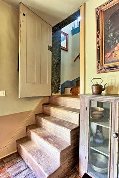 a set of stairs leading up to a painting on the wall