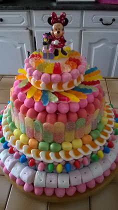 a mickey mouse cake with lots of candy on top