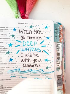 an open bible with the words when you go through deep waters, i will be with you