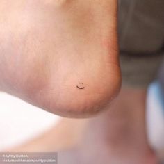 a person's foot with a small smiley face on it