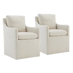 a pair of white chairs sitting next to each other