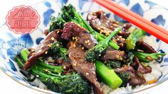 beef and broccoli stir fry in a bowl with chopsticks