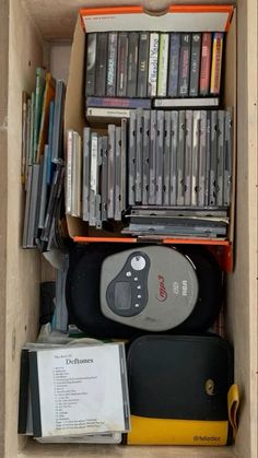 an open cardboard box filled with many different types of video game discs and games on top of each other