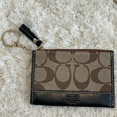 New Without Tags (Never Used) Top Zipper Closure Slip Pocket In Back Gold Keychain/Hardware Black Lining/ Black Leather Accents Width - 4 ½" Height - 3 ¼" Can Tuck Keychain Inside If Not Using Perfect For Credit Cards To Throw Inside A Bigger Purse Elegant Brown Coach Coin Purse, Coach Coin Purse With Zipper Closure, Brown Rectangular Coach Coin Purse, Black Coach Coin Purse, Coach Black Wristlet With Zipper Pouch, Purse Aesthetic, Coin Purse Wallet, Coach Bags, Purse Wallet