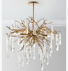 a chandelier hanging from the ceiling with many crystal drops in front of it