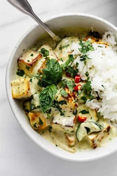 a white bowl filled with chicken and rice